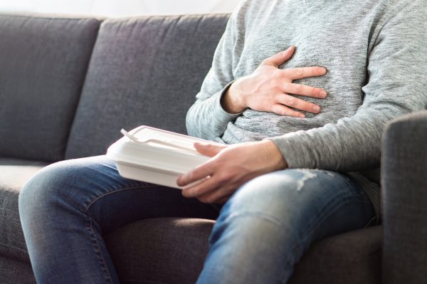 Man in pain holding his stomach