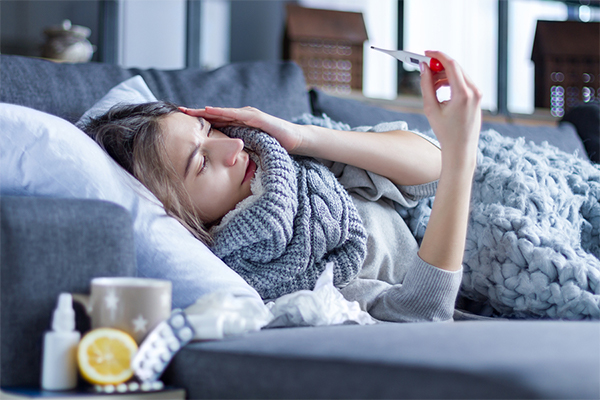 Woman sick on couch