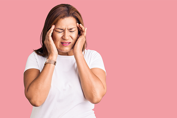 Older Hispanic woman having a headache