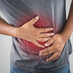 Photo of large intestine is on the man's body against gray background