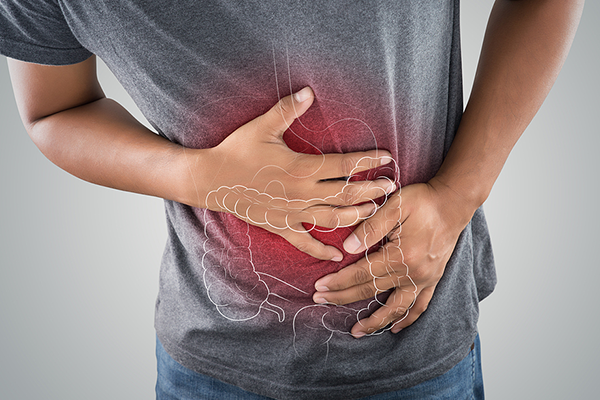 Photo of large intestine is on the man's body against gray background