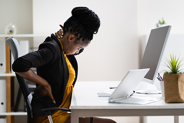 Black woman holding back in pain