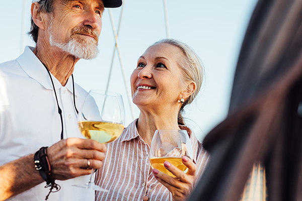 Older man and woman drinking wine