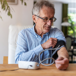 Older male taking blood pressure