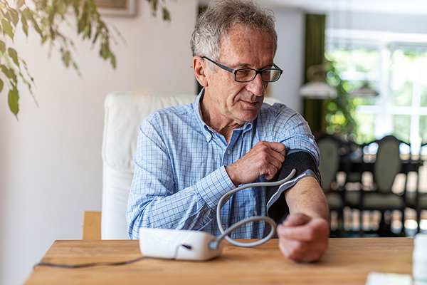 Older male taking blood pressure