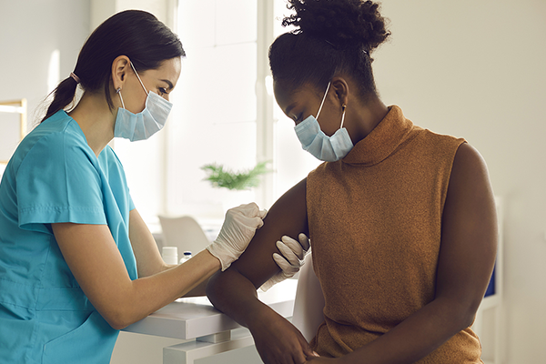 African American woman getting COVID-19 vaccine