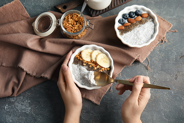 Woman eating chia seeds and fruit