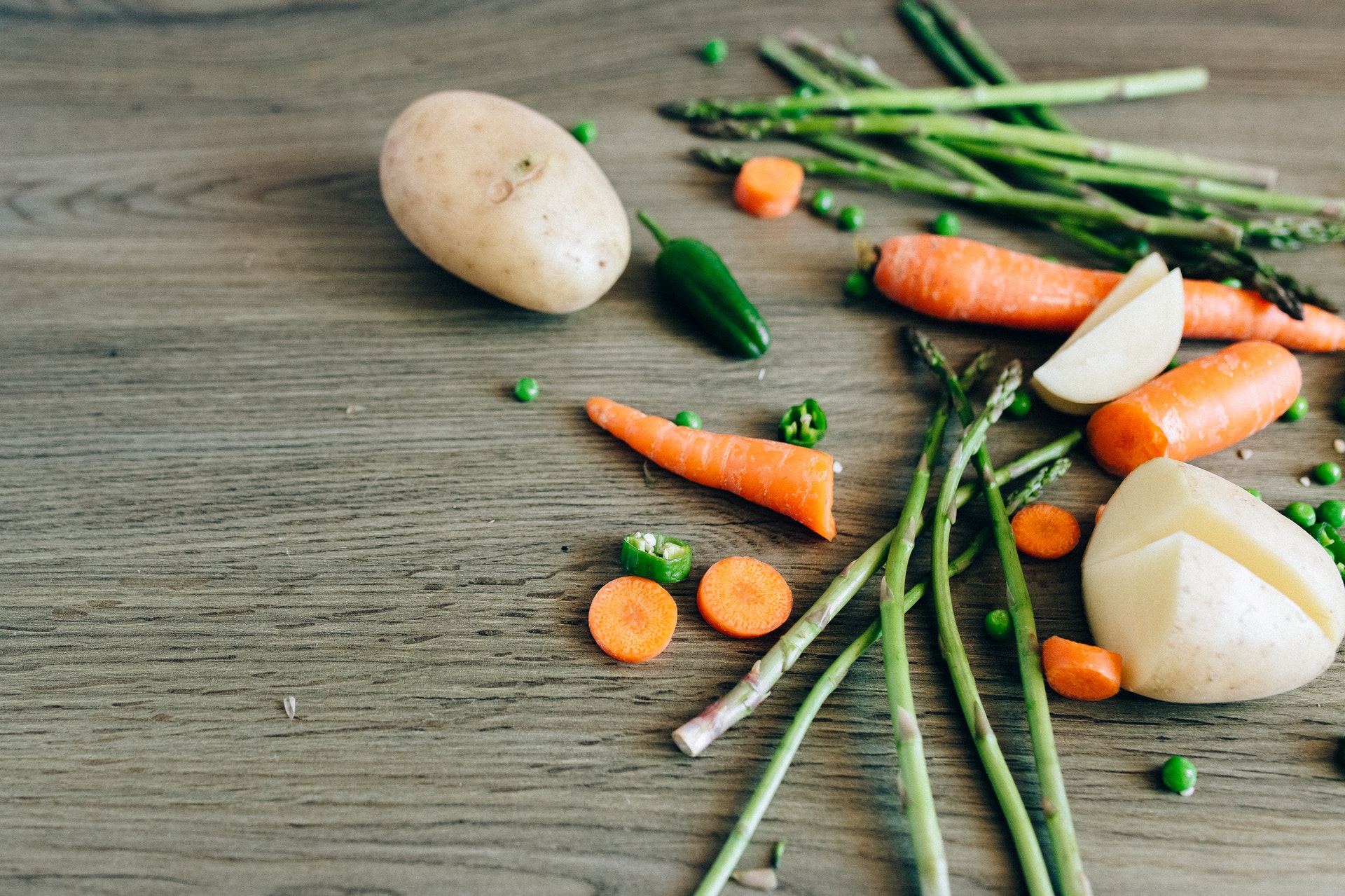 Different types of vegetables sitting on a wooden table