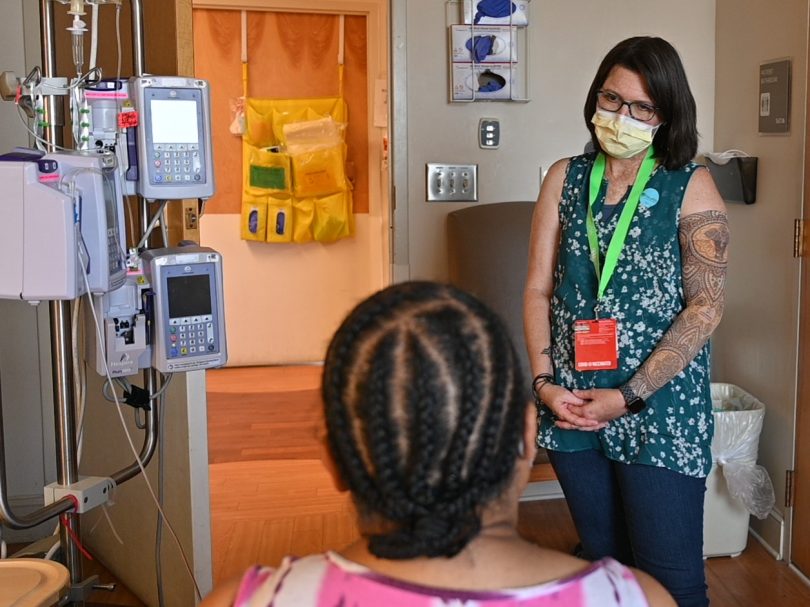 Female cancer survivor shares her experiences during the treatment process during a visit with patient undergoing care