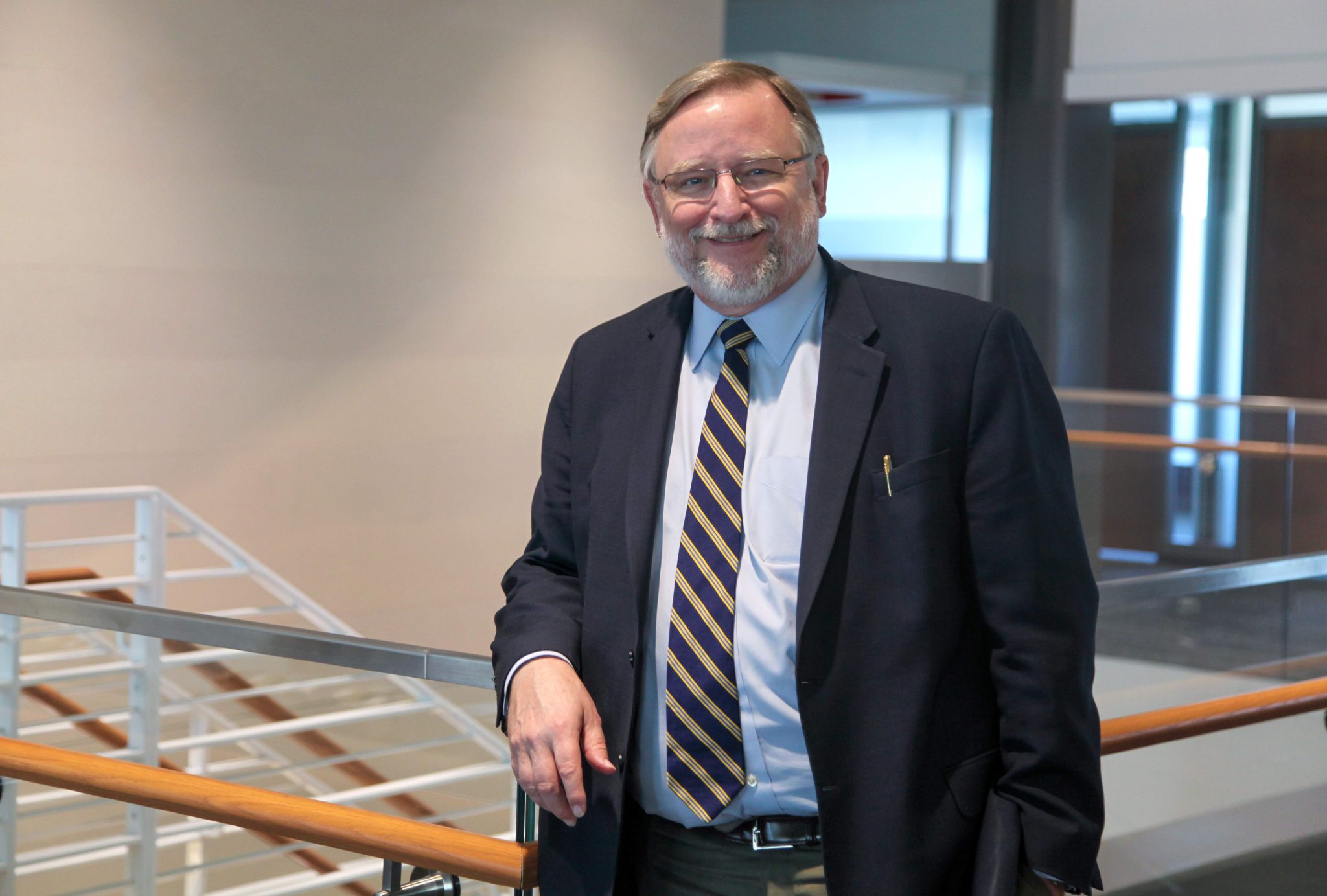 Dr. John Henson standing inside the Georgia Cancer Center's Collaborative Connector building