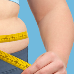 Woman measuring her waistline while deciding whether to have surgery to help her loose weight.