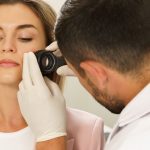 woman getting skin looked at by doctor