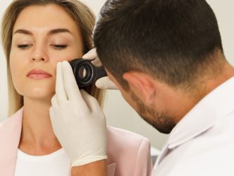 woman getting skin looked at by doctor