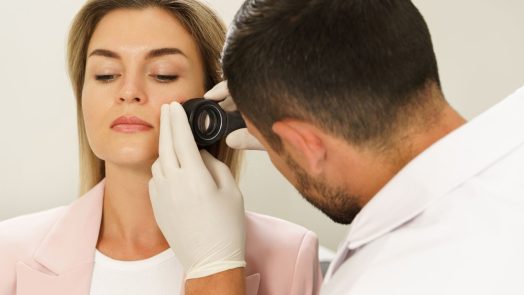 woman getting skin looked at by doctor
