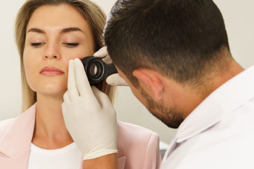 woman getting skin looked at by doctor