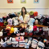 Young girl sitting with blankets
