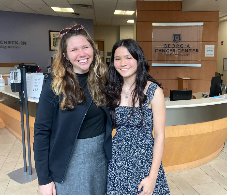 two girls smiling at camera