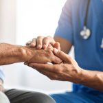 doctor holding patient's hand