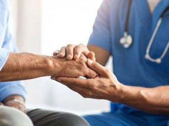 doctor holding patient's hand