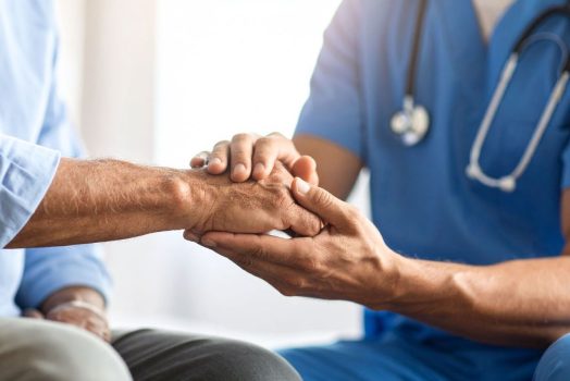 doctor holding patient's hand