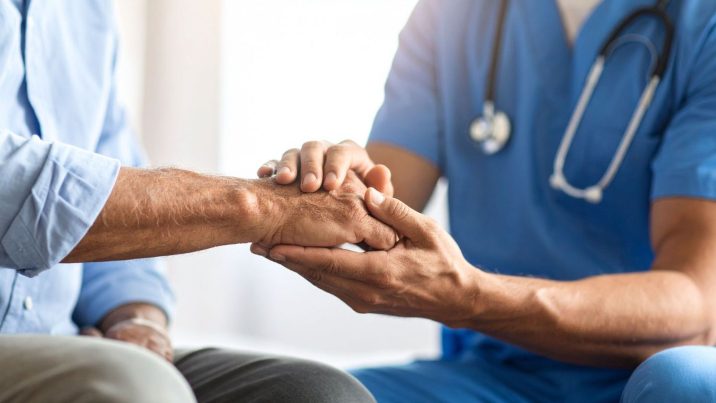 doctor holding patient's hand