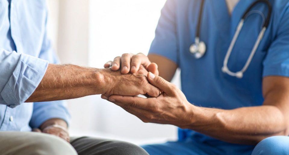 doctor holding patient's hand