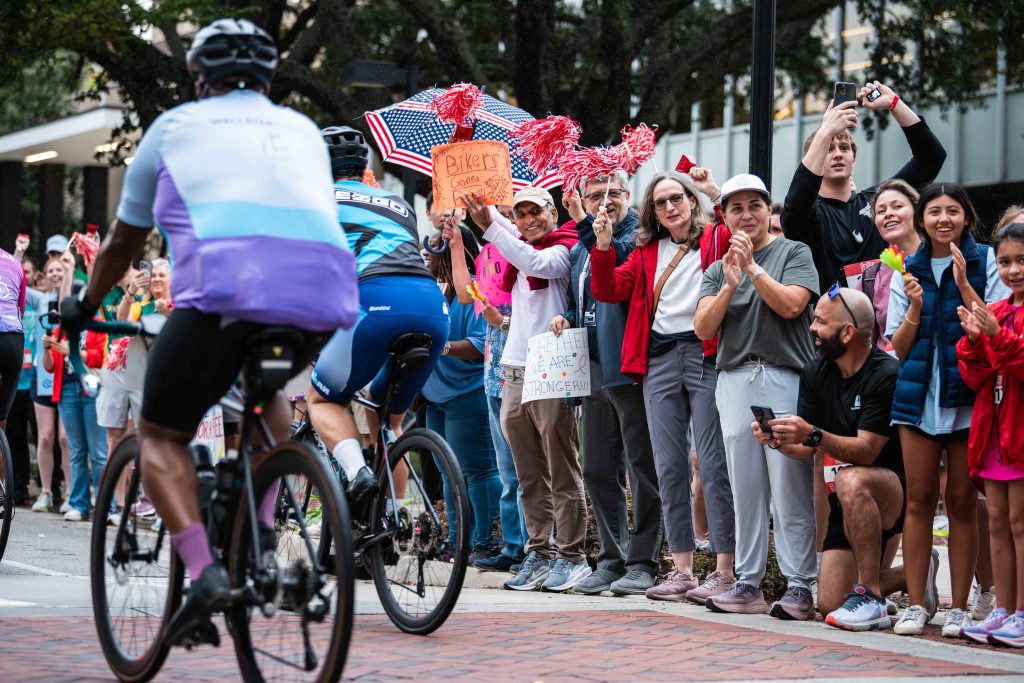 a crowd cheering bike riders