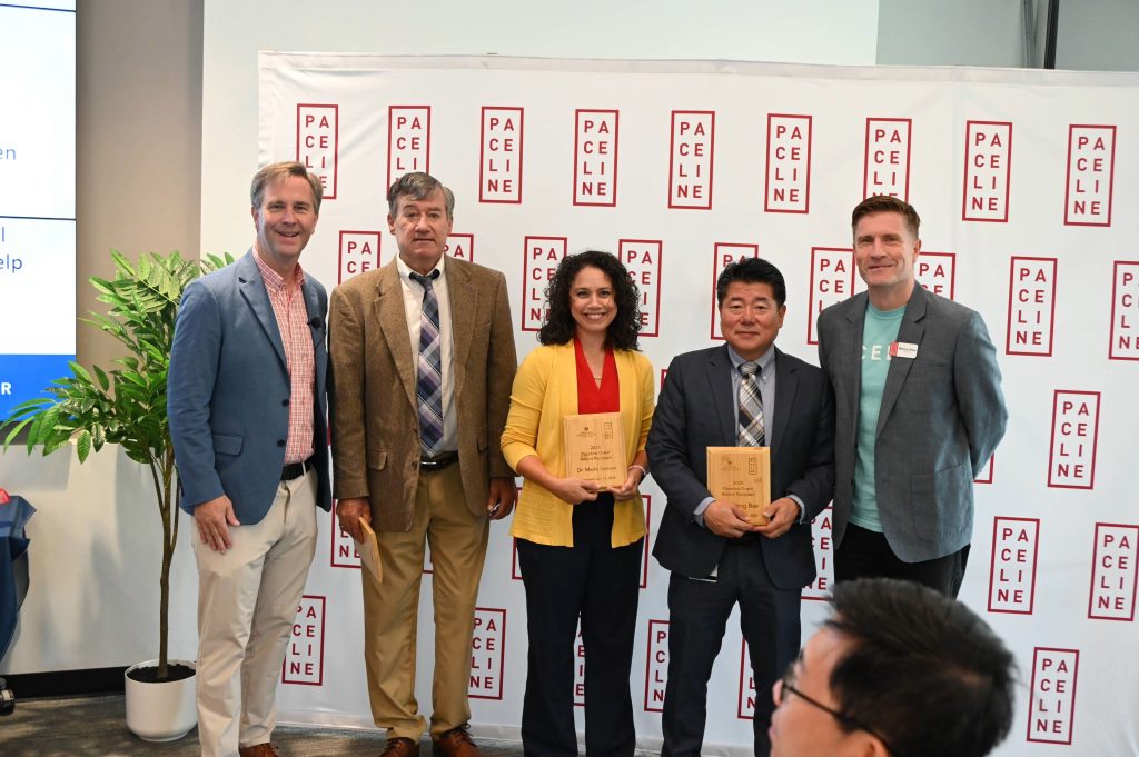 three people winning an award